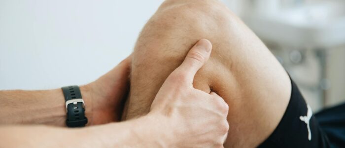 Photo by Funkcin?s Terapijos Centras Close-up of a physiotherapist massaging a patient's knee during therapy.
